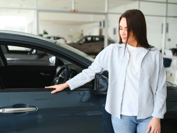 Woman Inspecting a Car