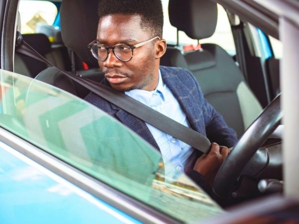 Man Driving a Blue Car