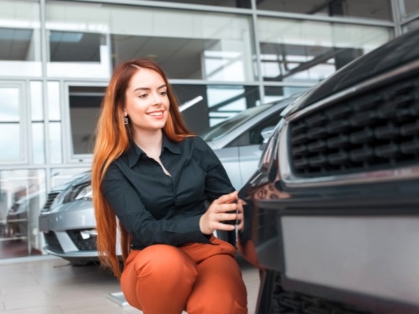 Woman inspecting a Car