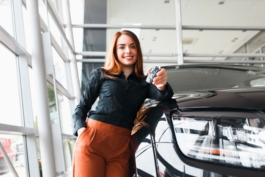 Woman Standing Beside a Black Car