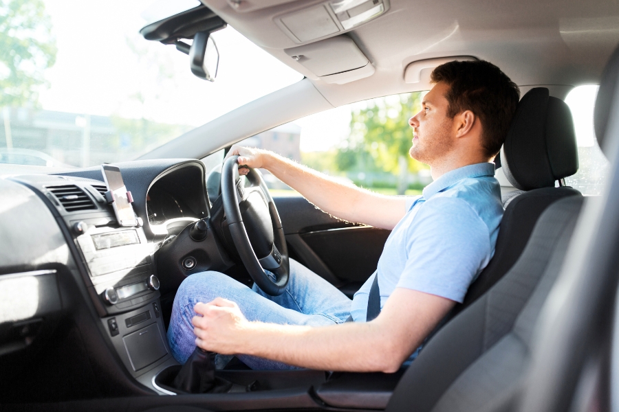 Man Driving a White Car
