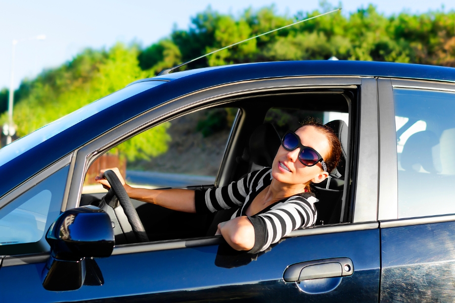 Woman Driving a Blue Car