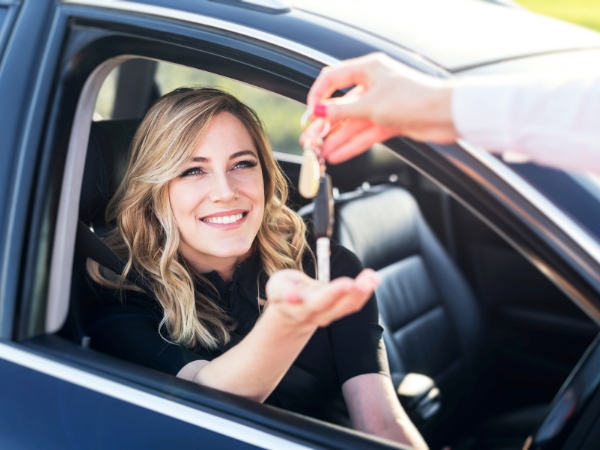 Woman Driving a Black Car
