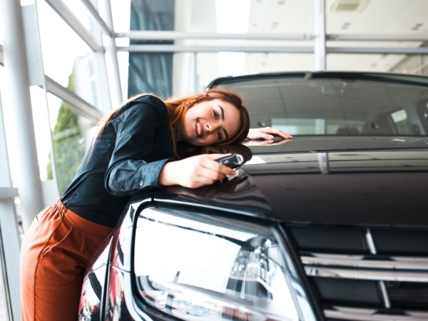 Woman Standing Beside a Black Car