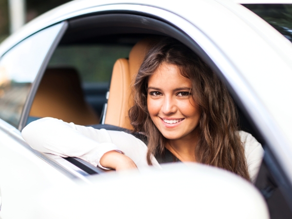 Woman Driving a White Car