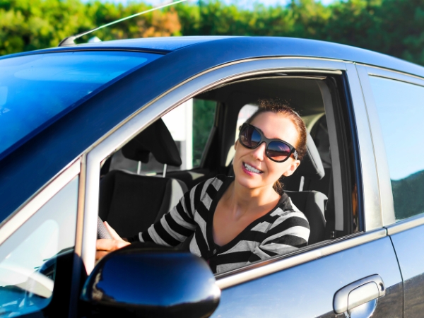 Woman Driving a Blue Car